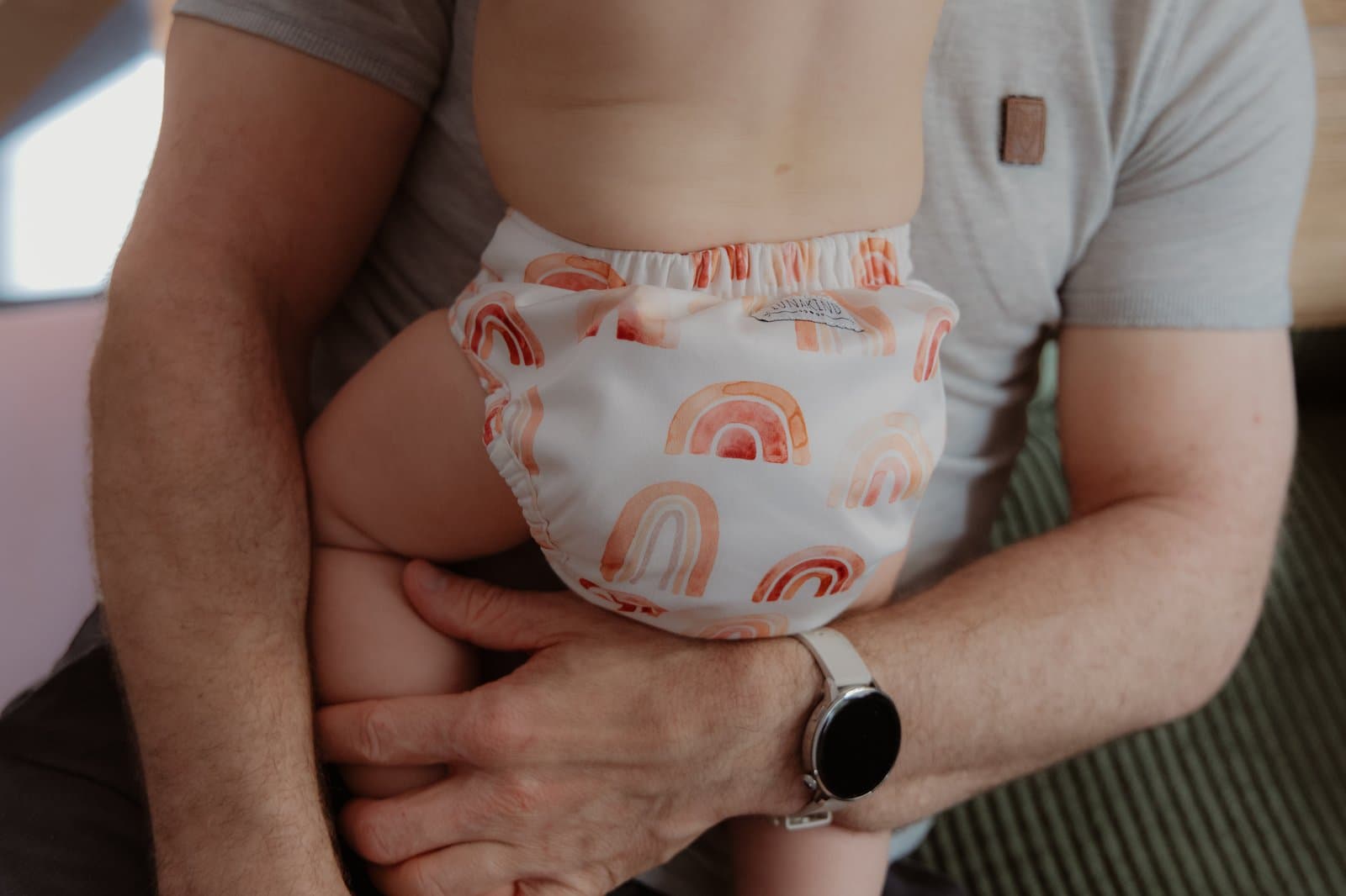 Dad holding a baby, cloth diaper
